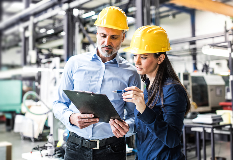 Engineers reviewing safety information for layers of protection analysis in an industrial facility.